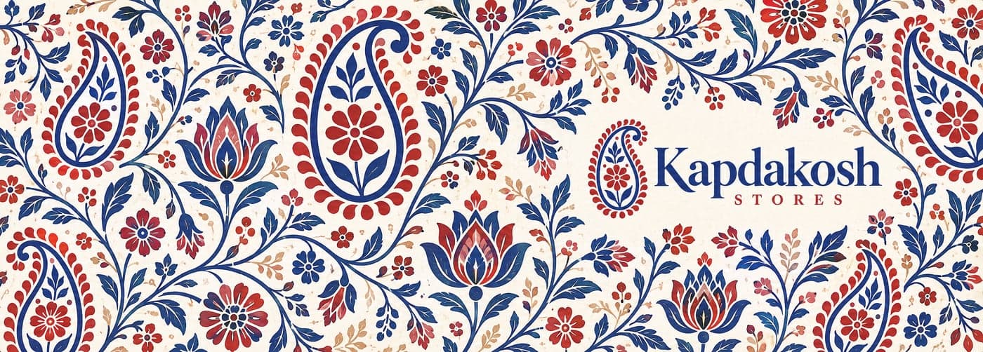 Flat print sheet: a dense block-print textile of paisleys and florals in indigo and madder red on cream, with the Kapdakosh Stores logo on the right half.